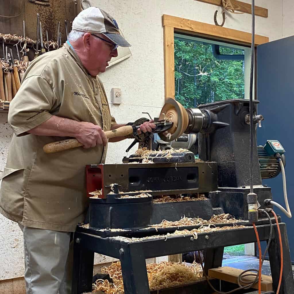 Artist turning a bowl at the lathe